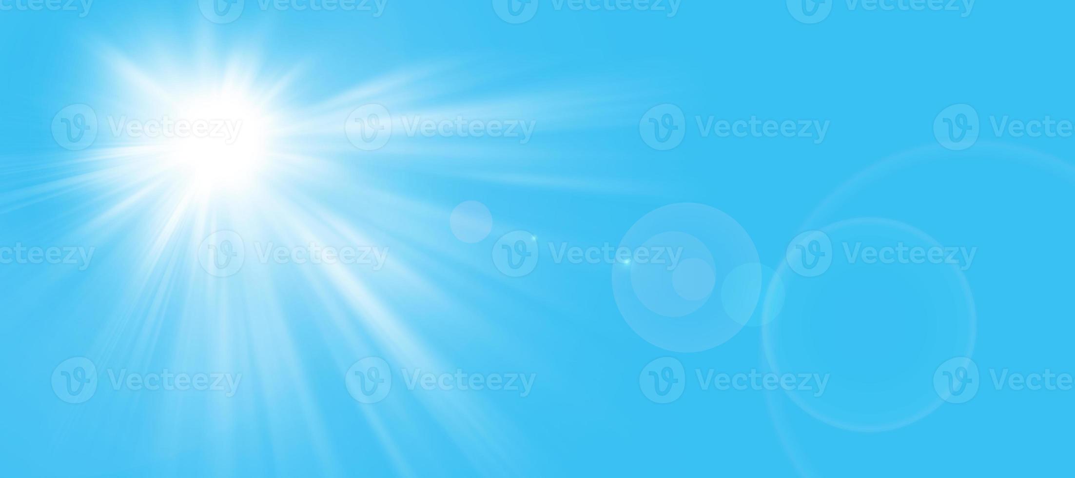 Sunny background, sun in summer on blue sky with lens flare. The sun's rays and the lens light up in a bright blue sky.Panorama format. Space for your own text. photo