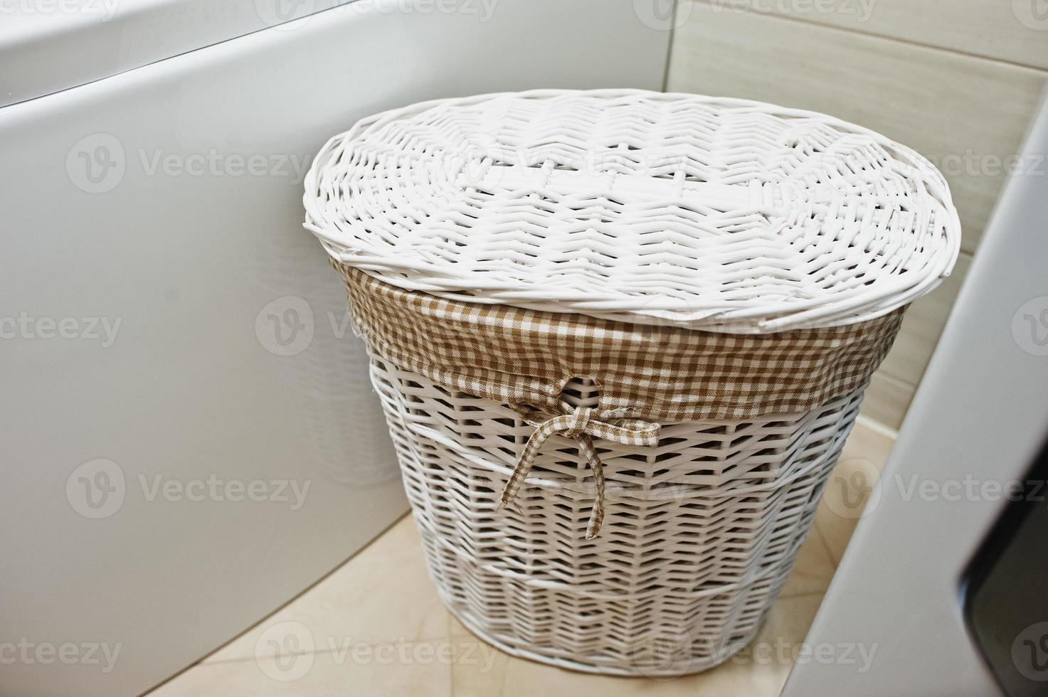 White wicker basket for dirty clothes at bathroom photo