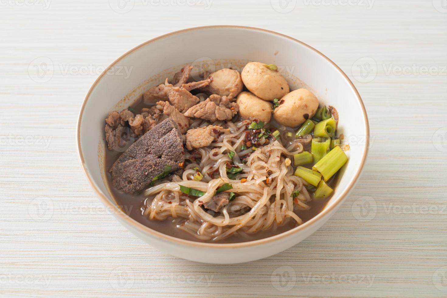 Thai noodle with pork, stewed pork, meatball and pork liver in blood soup photo