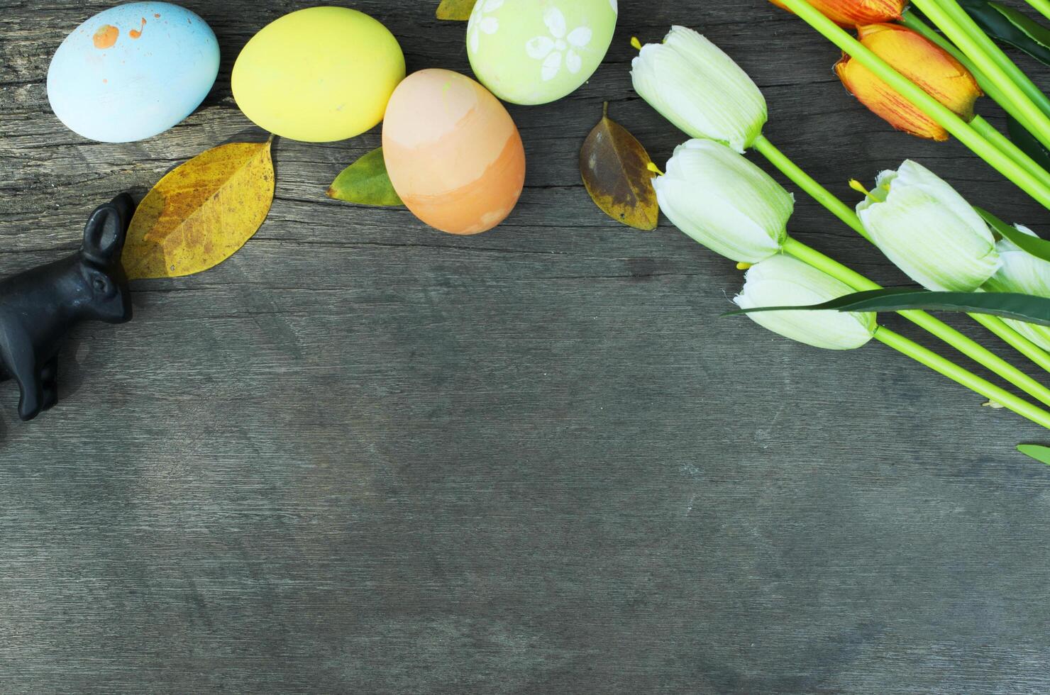 Easter eggs and rabbit with decoration on old wood backgrounds above frame with copy space for your text photo