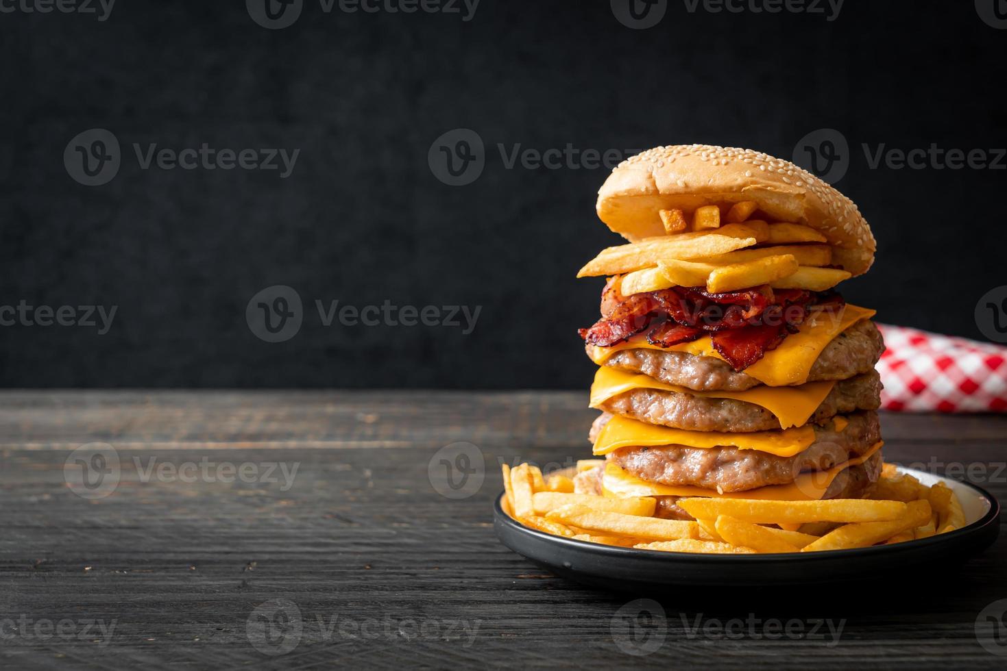 pork burger with cheese, bacon and french fries photo