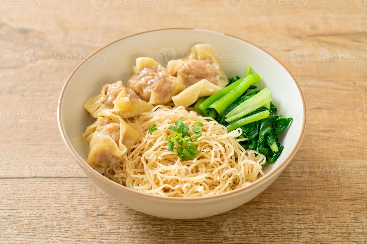 dried egg noodles with pork wonton or pork dumplings without soup photo