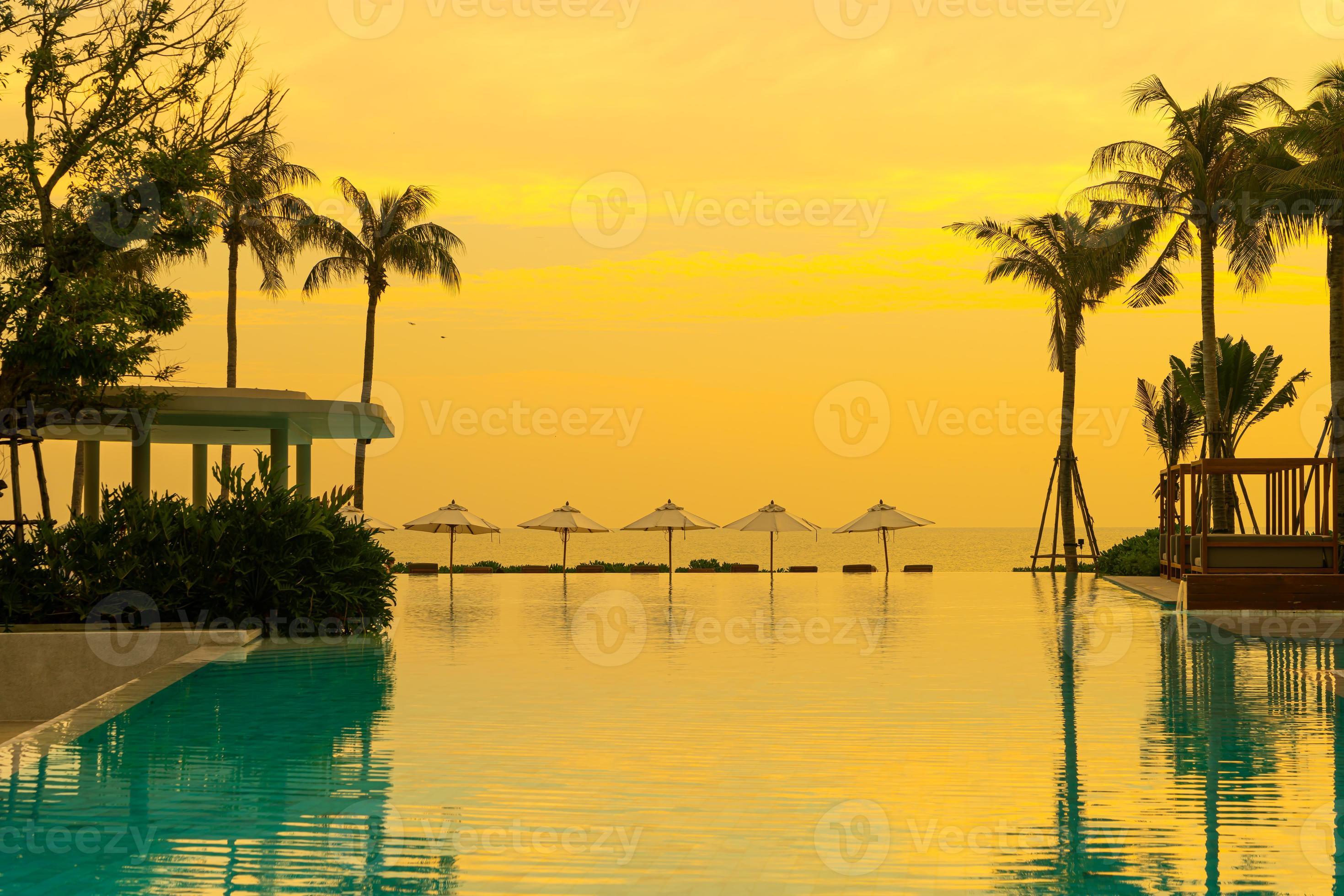 umbrella with bed pool around swimming pool with ocean sea background