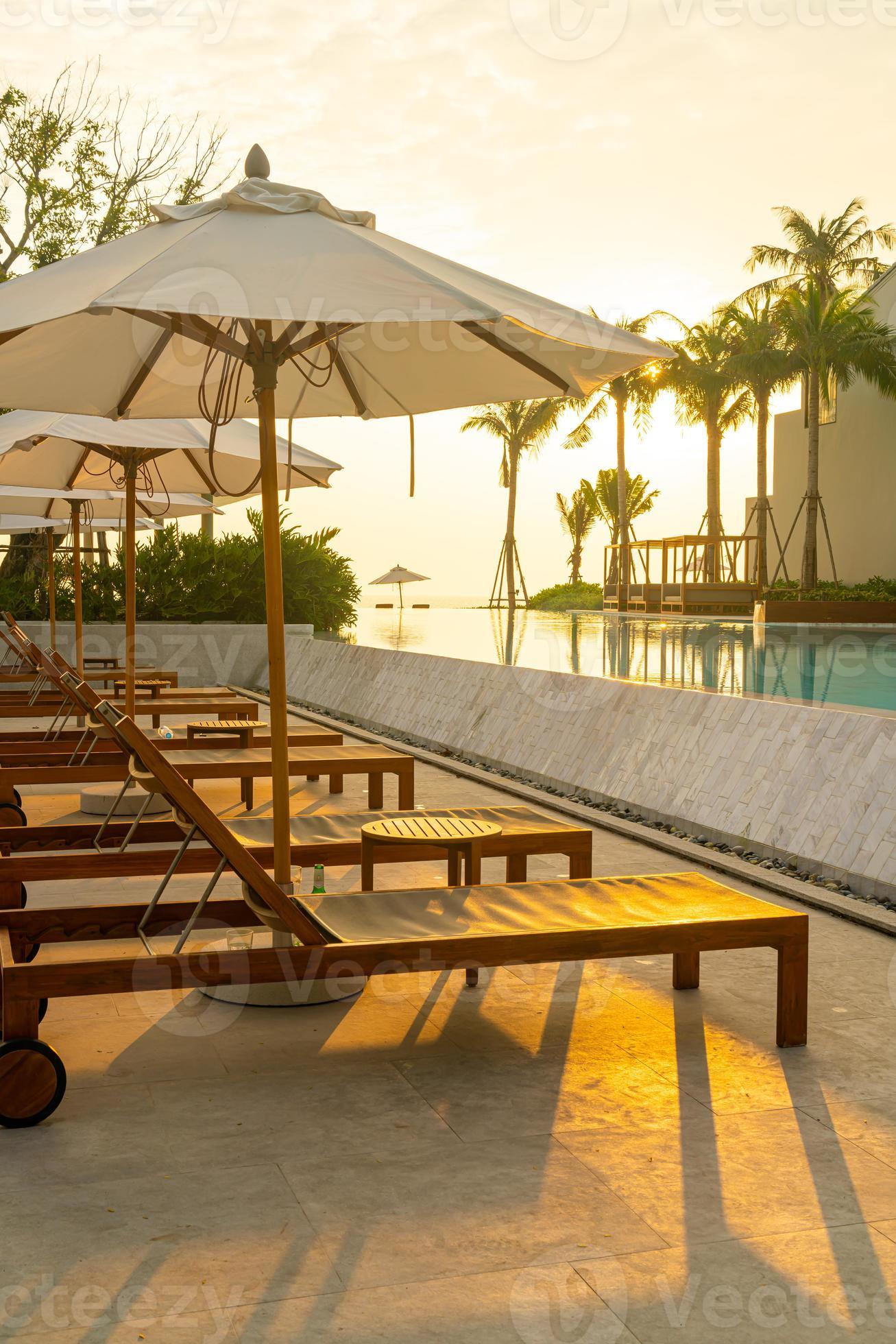 umbrella with bed pool around swimming pool with ocean sea background