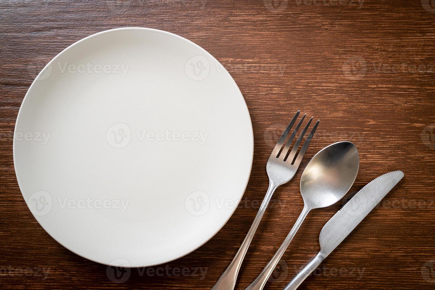 empty plate or dish with knife, fork and spoon photo