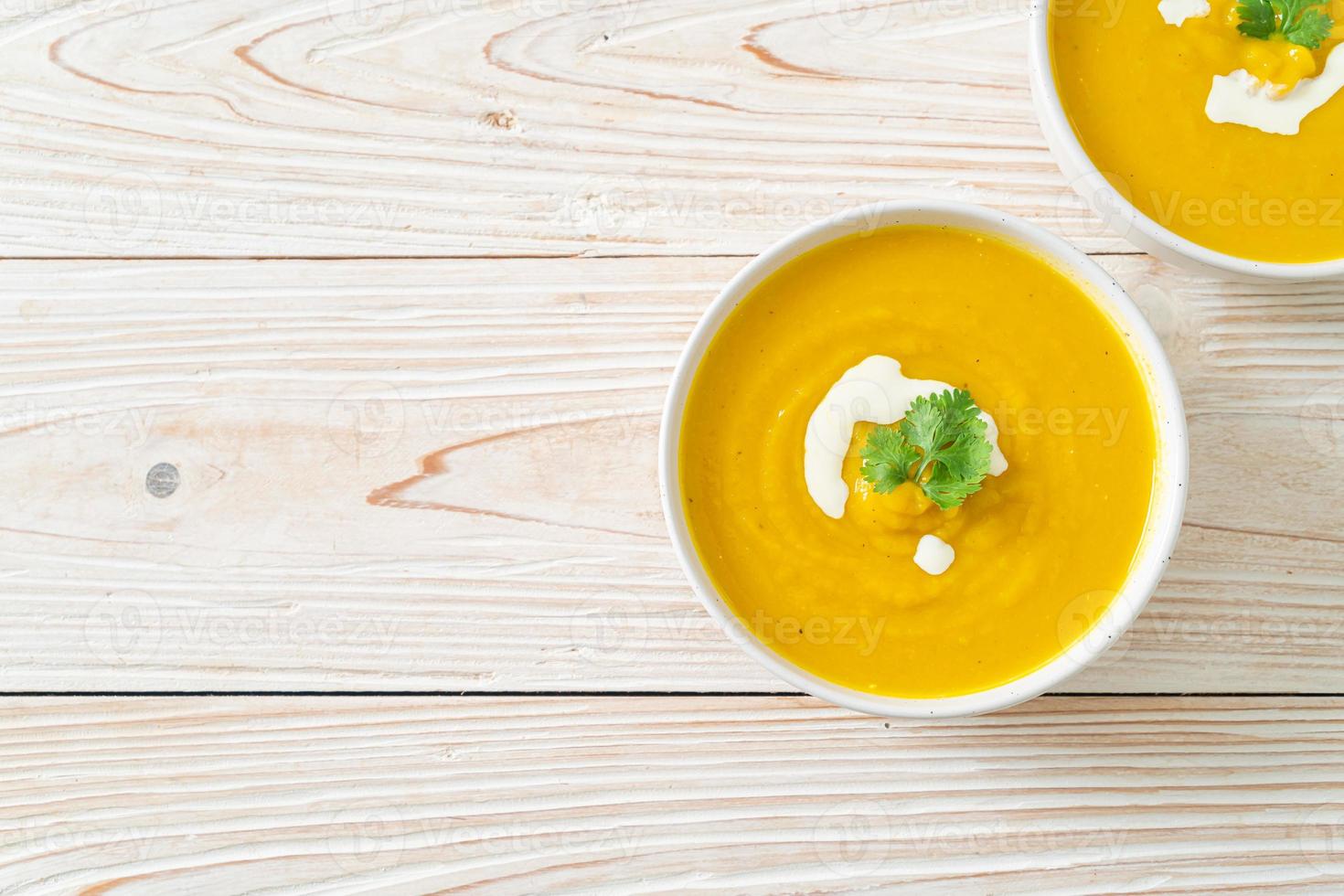 pumpkin soup in white bowl photo