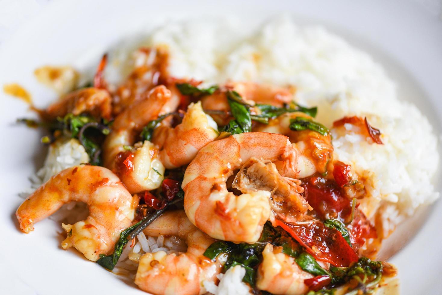 Stir fried shrimp, Cooked rice and fried basil with shrimps prawns,Thai food rice topped shrimp with holy basil leaves photo