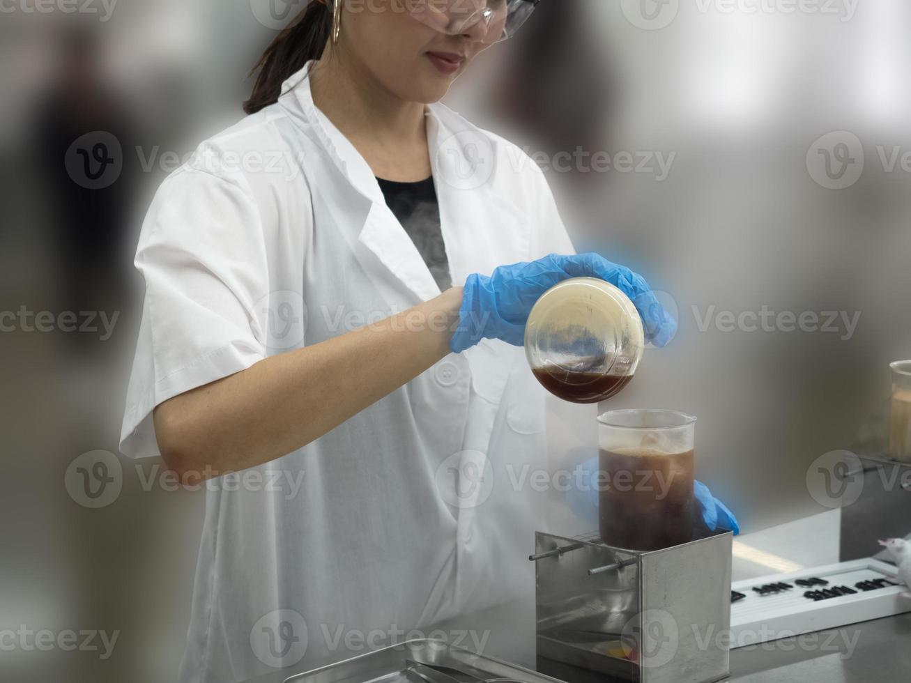 Hospital clinic laboratory doctor nurse scientist female protect ppe glove white blue uniform bottle technology test medical vaccine research treatment healthcare safety covid-19 corona virus patient photo