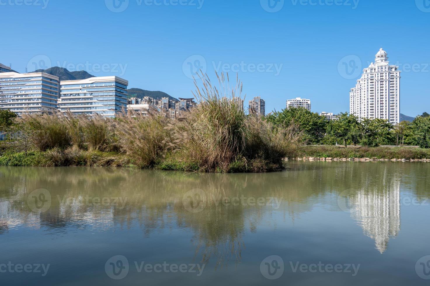 The river reflects the modern city buildings under the blue sky photo