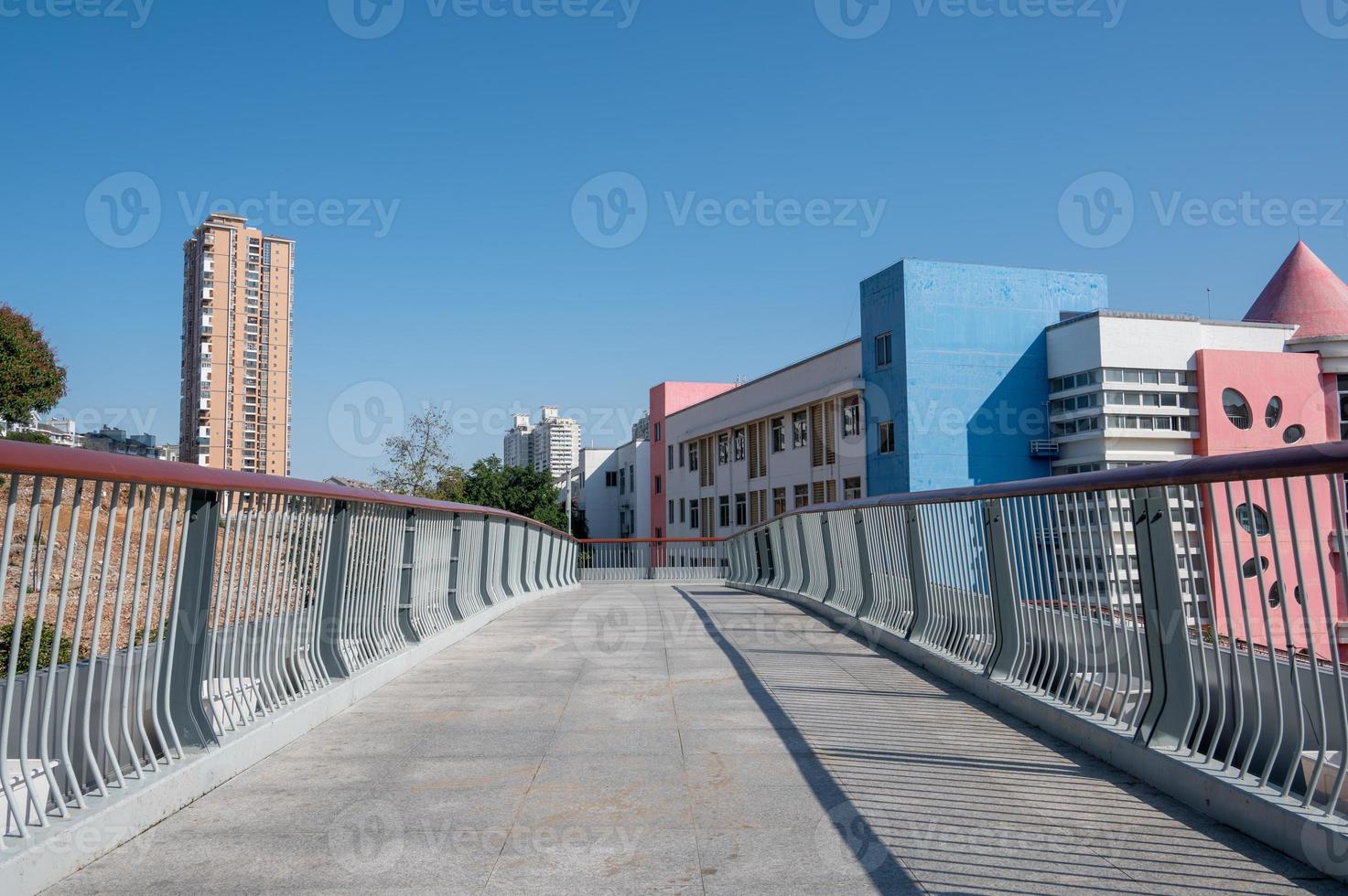 A pedestrian overpass composed of stone slabs and guardrails photo