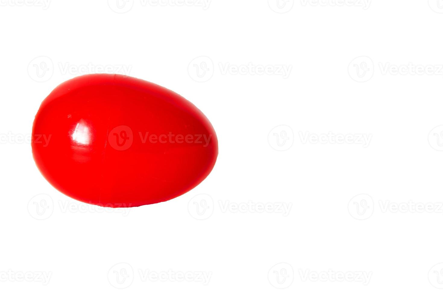 red plastic egg on a white background photo