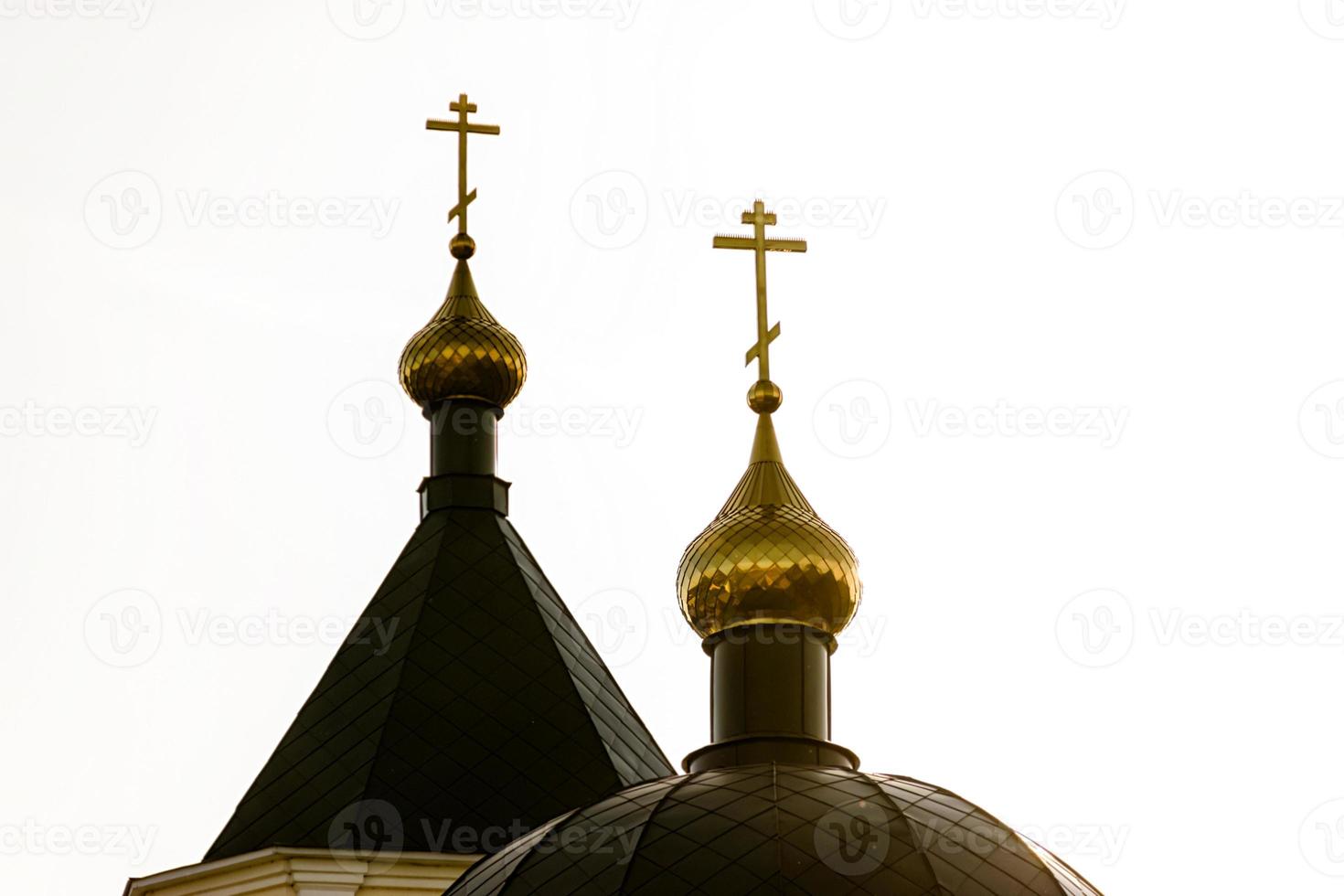 green domes of the chirch lit in the setting sun photo