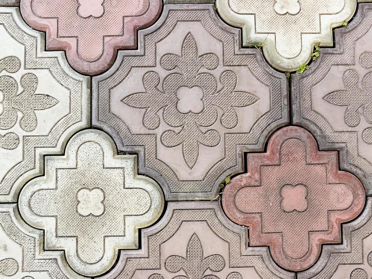 Sidewalk paved with rectangular red, white and gray tiles in perspective photo