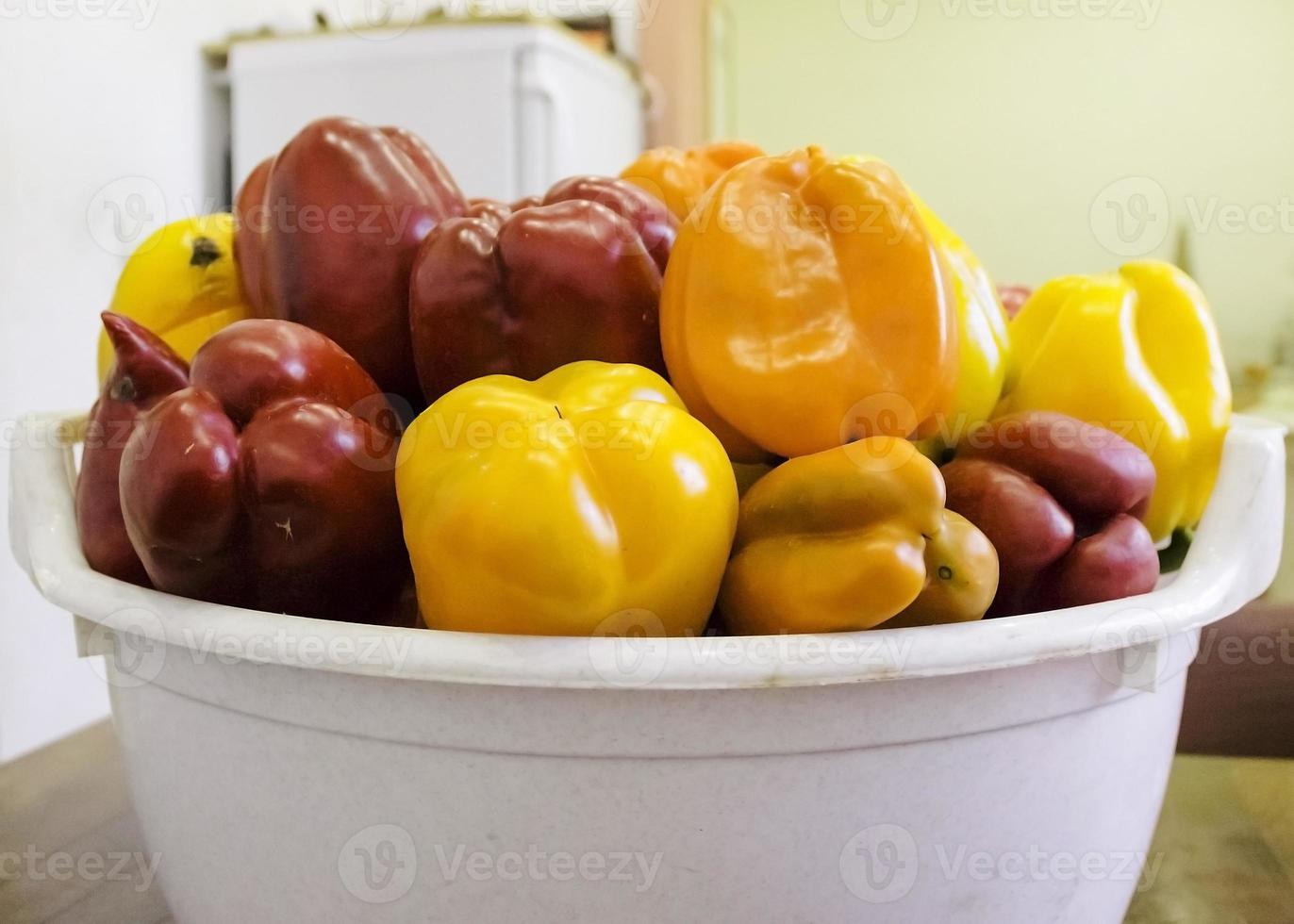 Red and yellow sweet bell peppers on table, close up photo