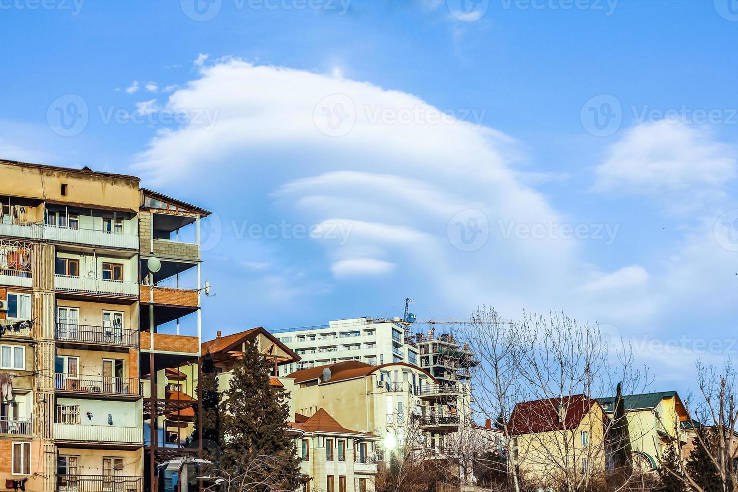 Beautiful clouds of unusual shape. Urban landscape with beautiful couds in the sky. photo