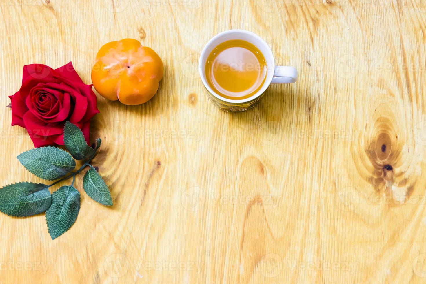 Fresh banana and persimmon in brick wall background and wooden table, photo