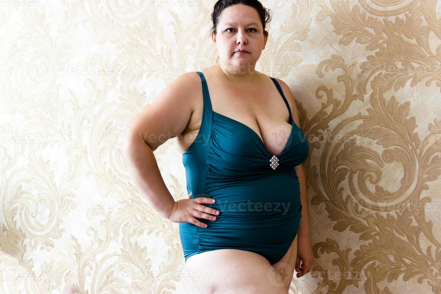 young woman posing in a turquoise swimwear photo