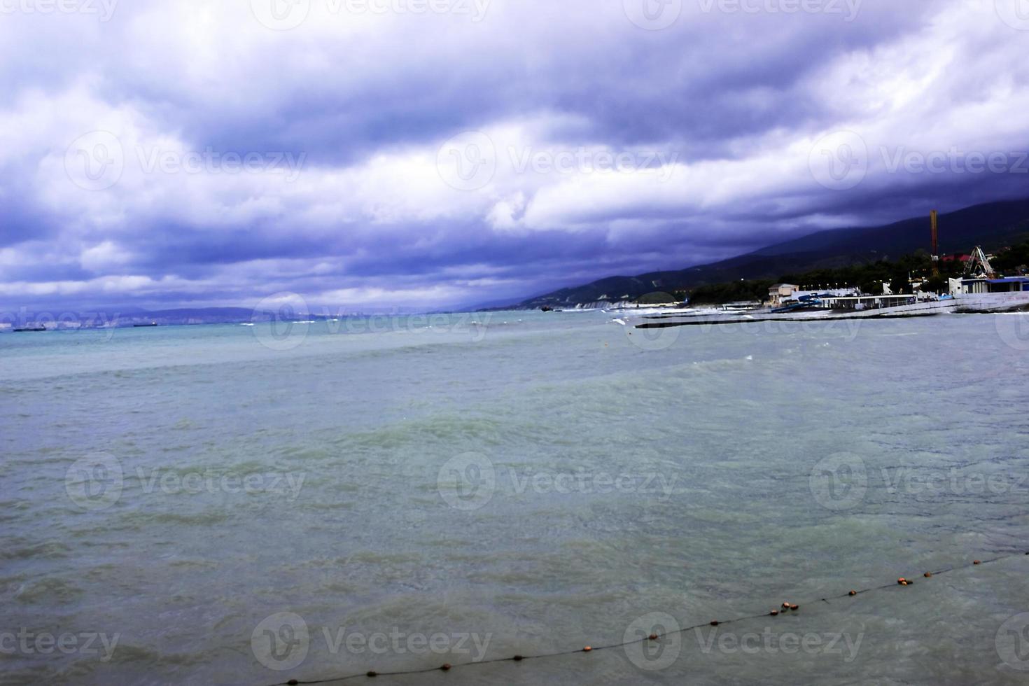 through the clouds over the sea a ray of sunshine makes its way photo