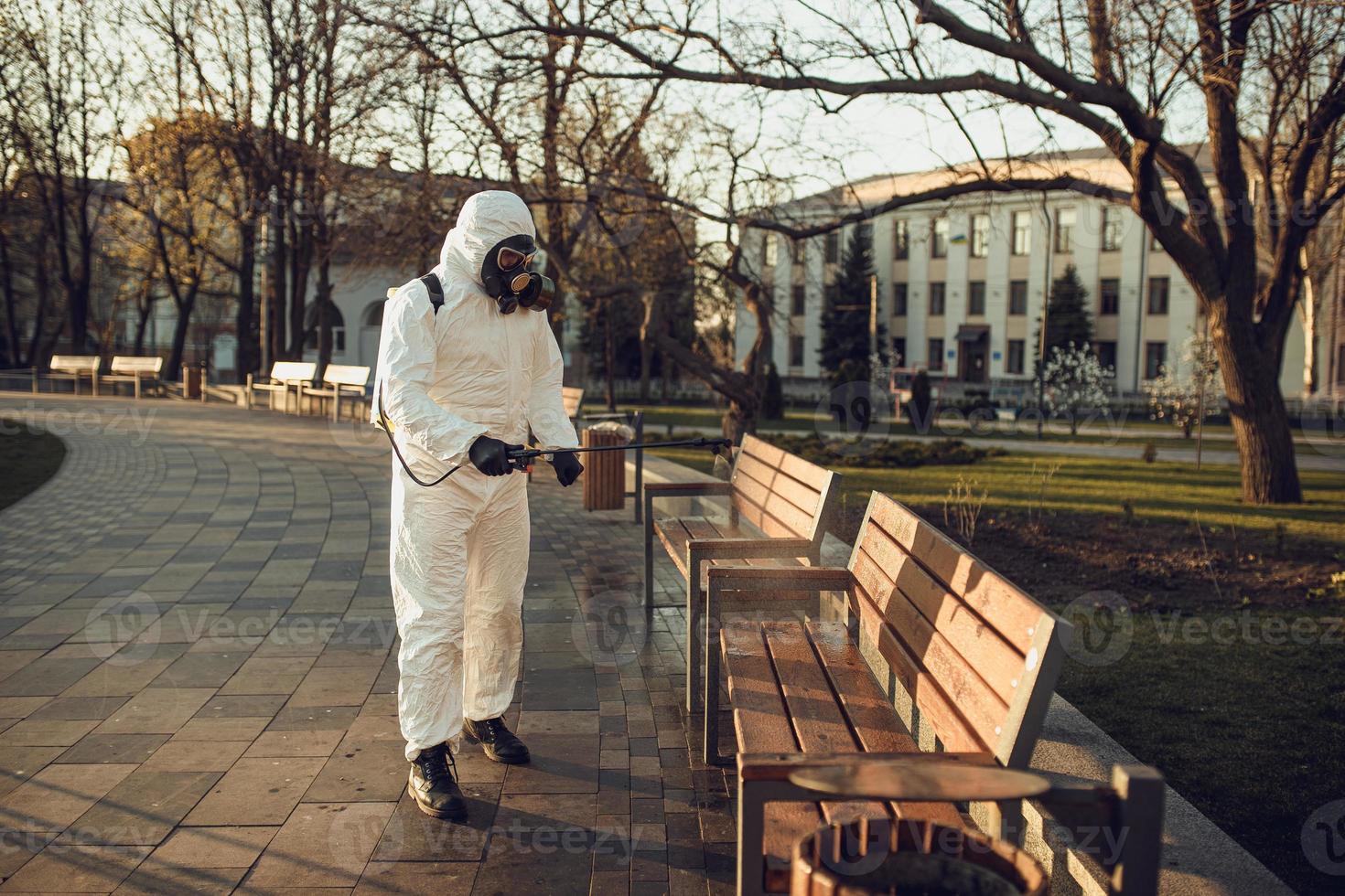 Cleaning and Disinfection on the playground in the sity complex amid the coronavirus epidemic Teams for disinfection efforts Infection prevention and control of epidemic Protective suit and mask photo