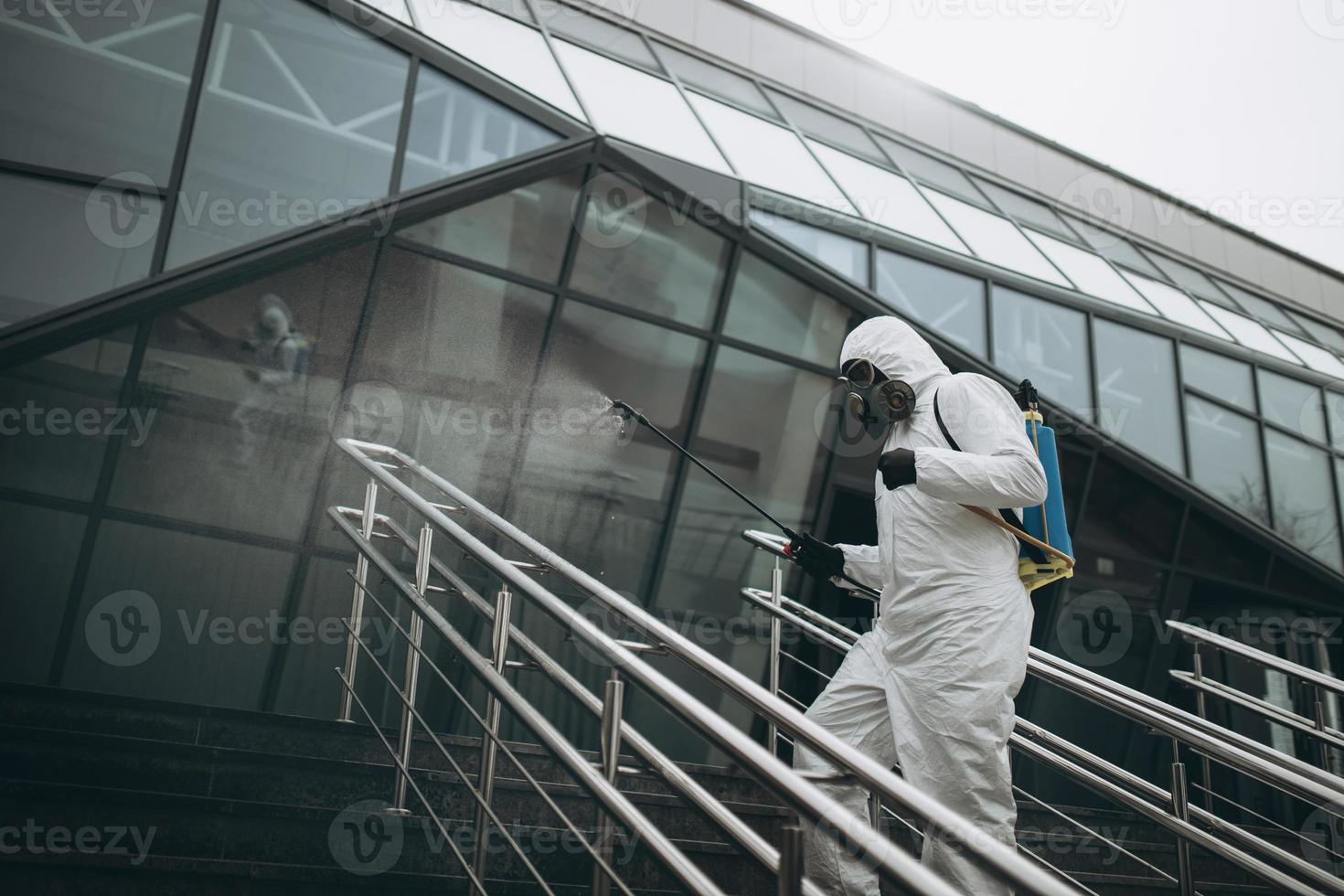 Cleaning and Disinfection at town complex amid the coronavirus epidemic Professional teams for disinfection efforts Infection prevention and control of epidemic Protective suit and mask photo