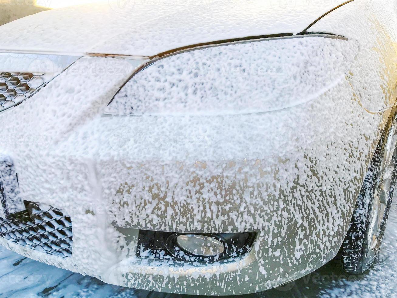 Manual car wash with pressurized water in car wash outside. Cleaning car using high pressure water. photo