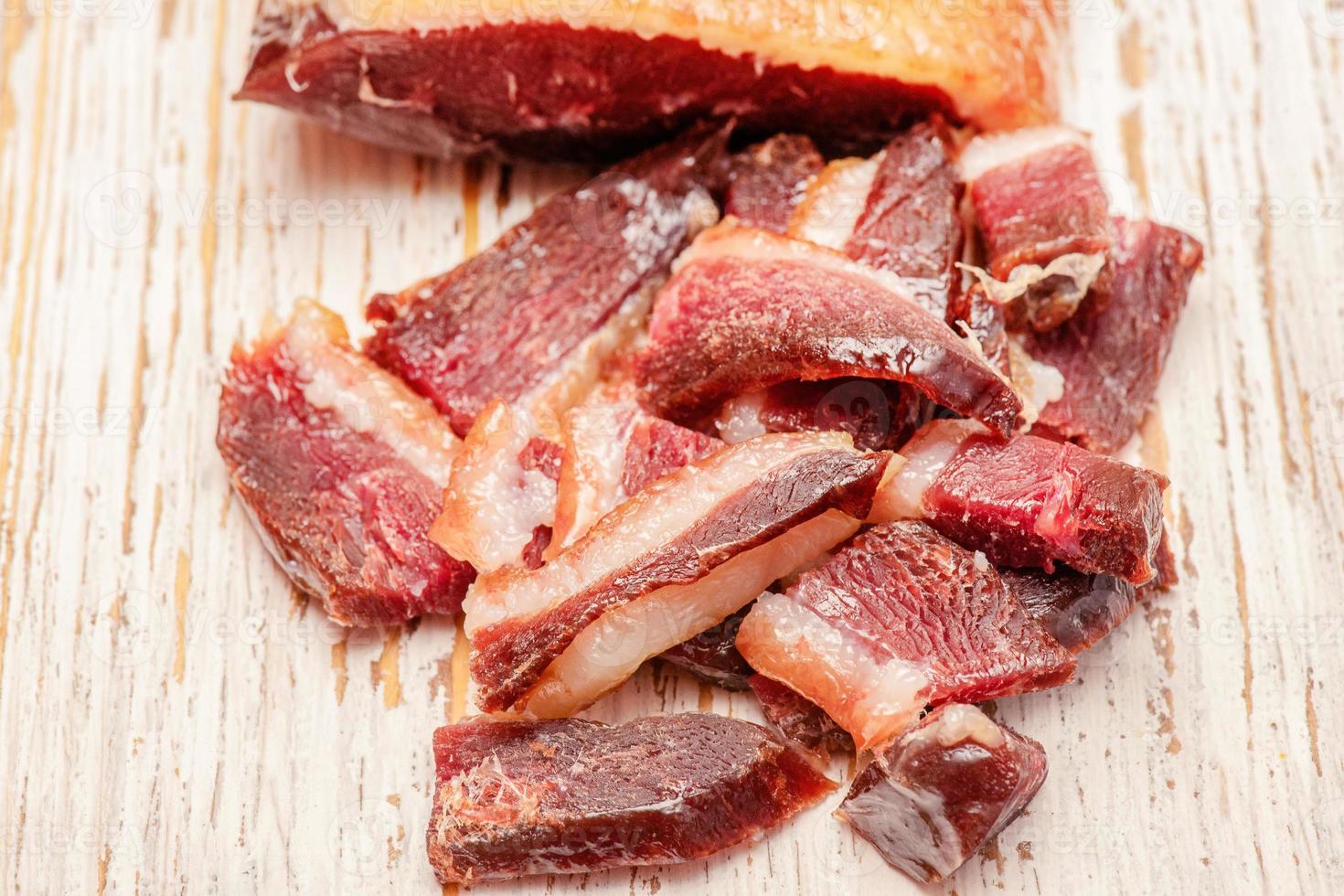 Food photography, poultry meat. Dry-cured duck on a white aged board. photo