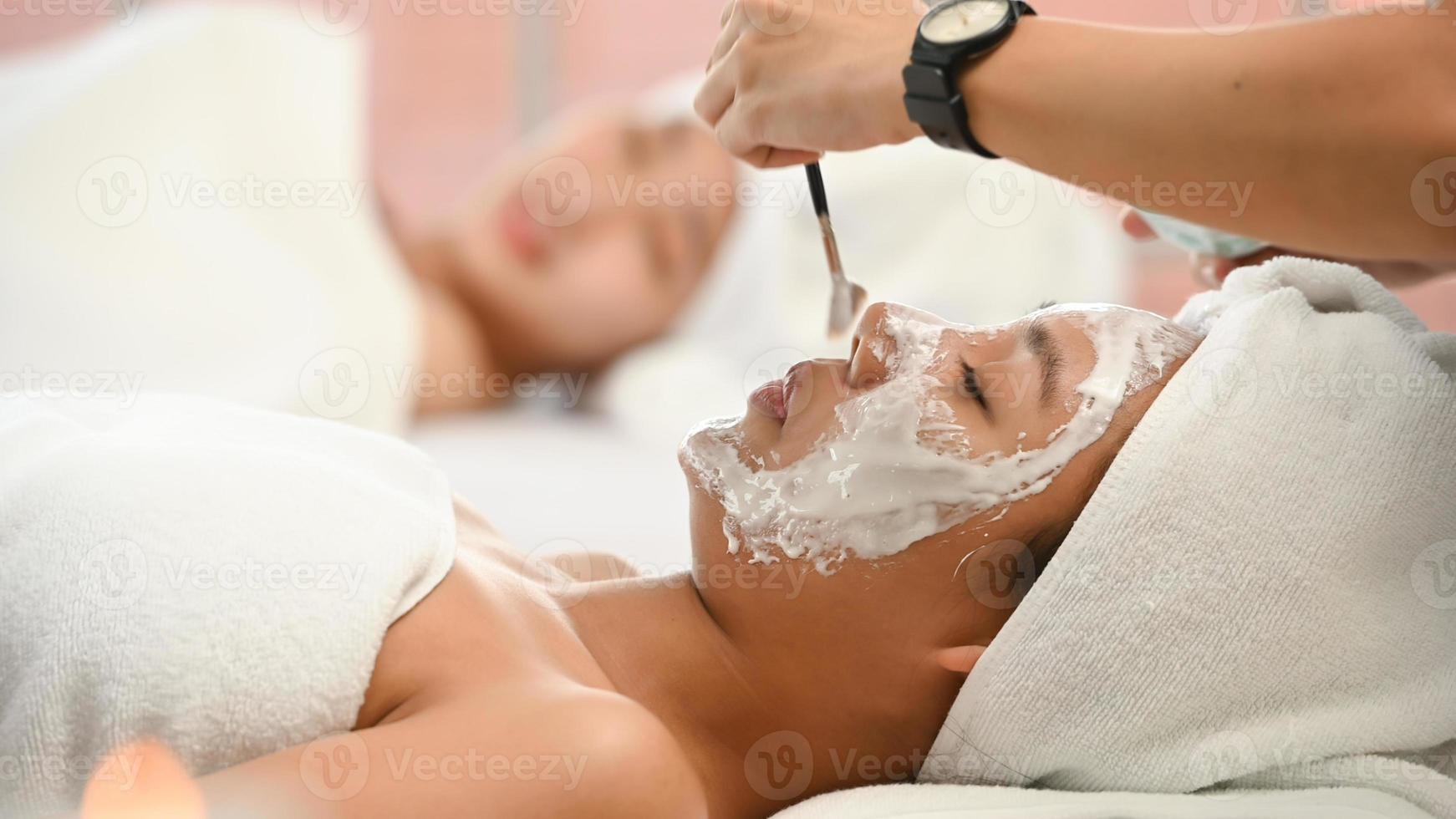Portrait of young beautiful asian woman enjoys massage in a luxury spa resort photo
