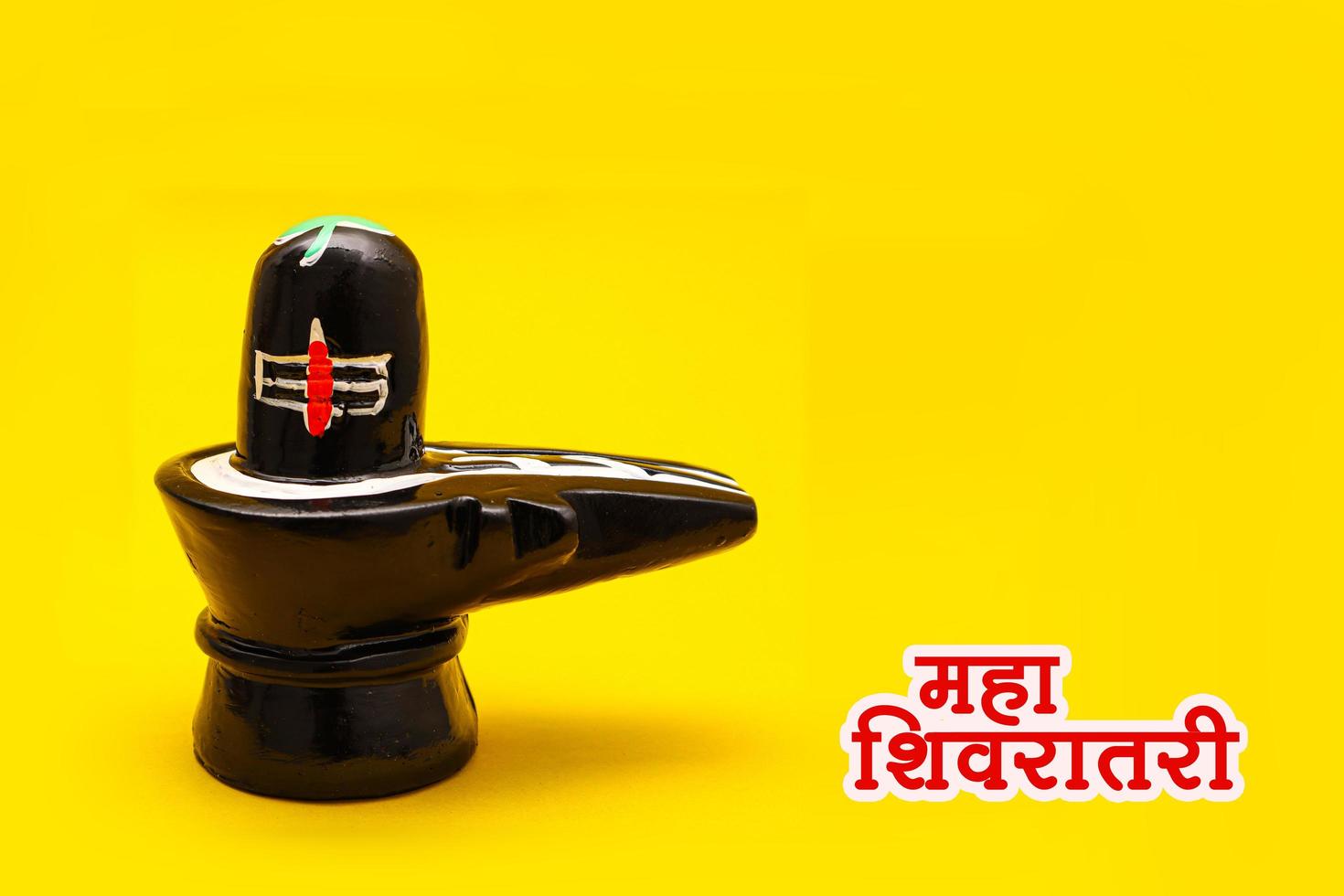 Shiva Linga on yellow background. photo