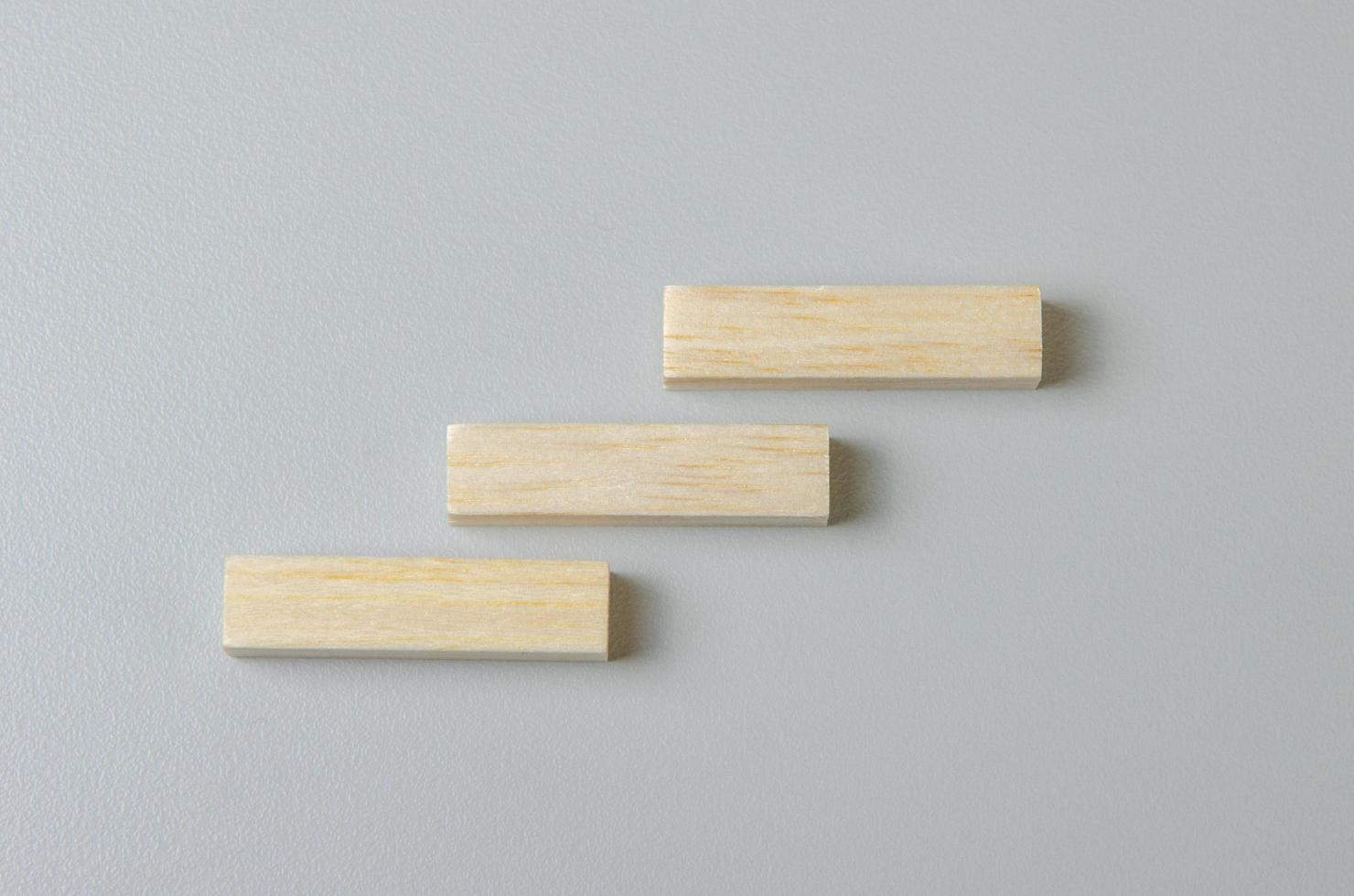 Blank wooden block for icons or symbols on gray background. photo