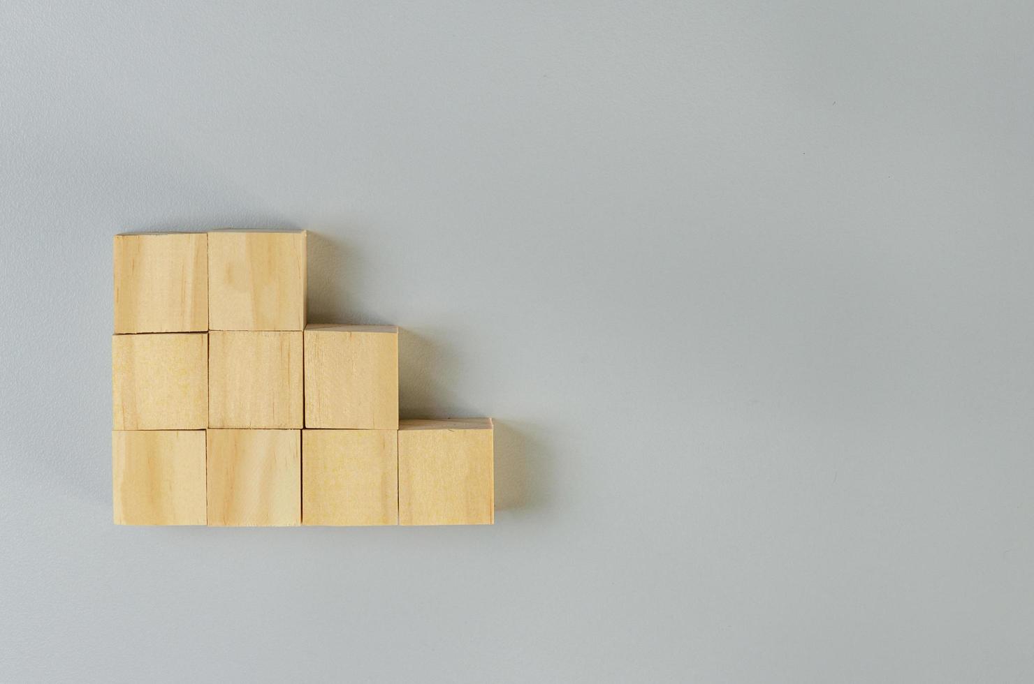 Blank wooden cubes for icons or symbols on gray background. photo