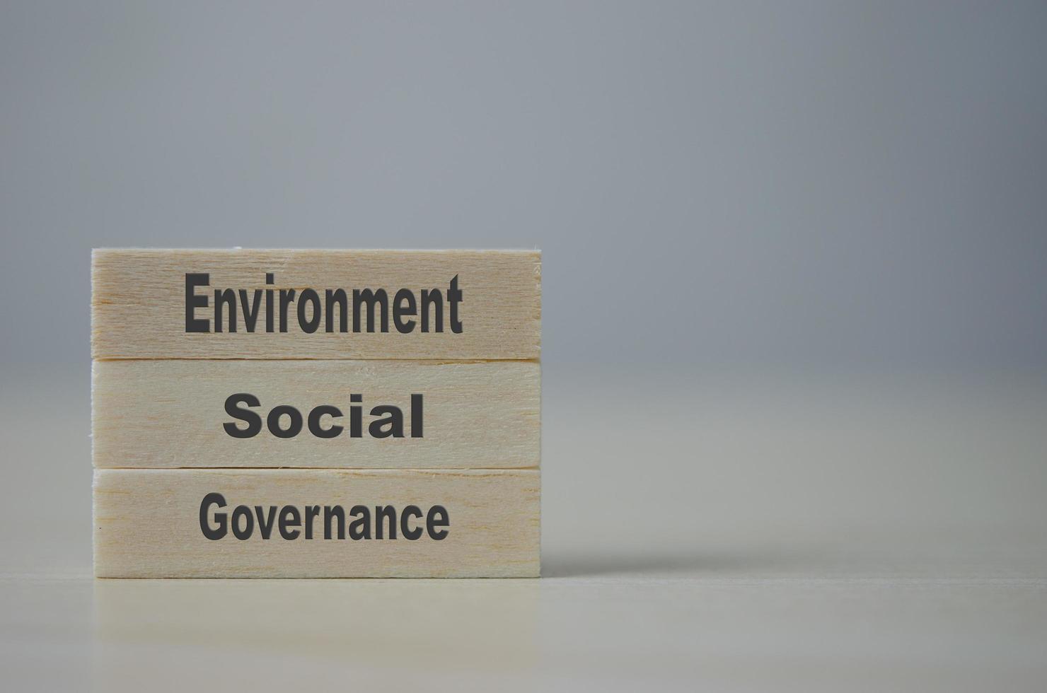 Wooden blocks with words ESG Environmental Social Governance on background and copy space.Business concepts. photo