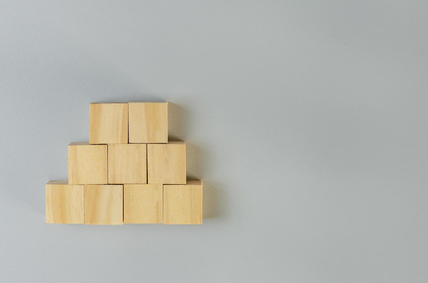 Blank wooden cubes for icons or symbols on gray background. photo