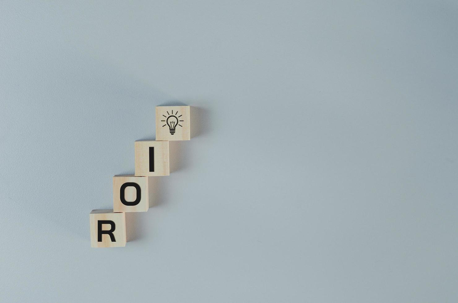 Wooden cubes with ROI Return on Investment symbol on background and copy space.Business concepts. photo