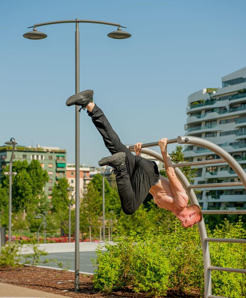 Milan Italy 2017 Boy doing gymnastics in the public park photo