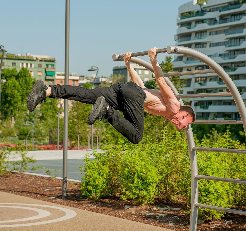 Milan Italy 2017 Boy doing gymnastics in the public park photo