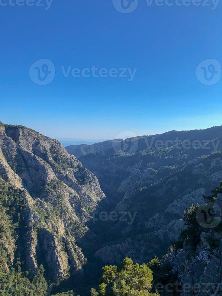 blue sky white clouds on the hill, mountain with a trees view. photo