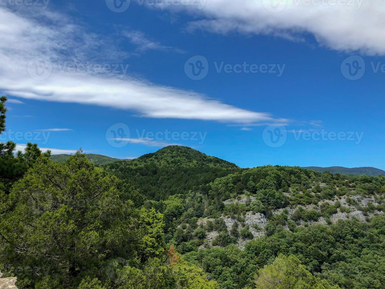 blue sky white clouds on the hill, mountain with a trees view. photo