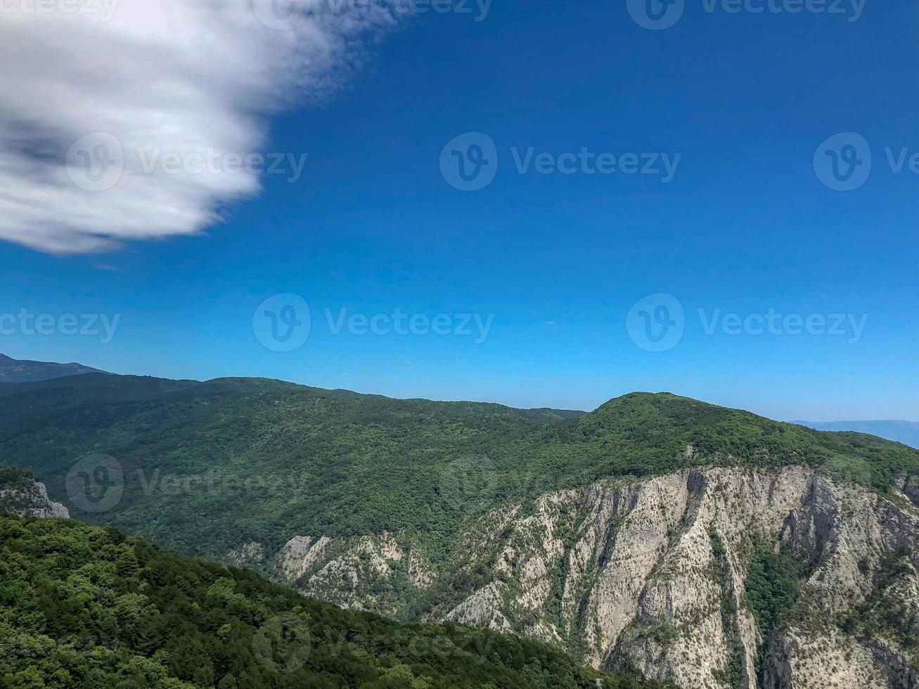 blue sky white clouds on the hill, mountain with a trees view. photo