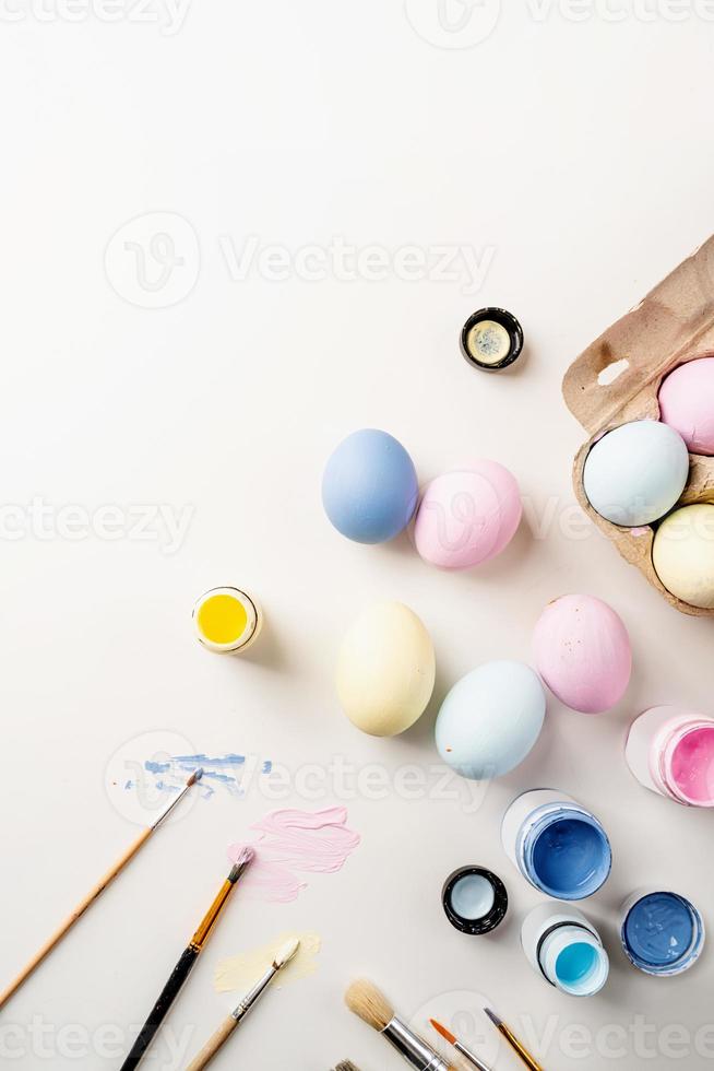 easter background with eggs with pastel paints, top view flat lay photo