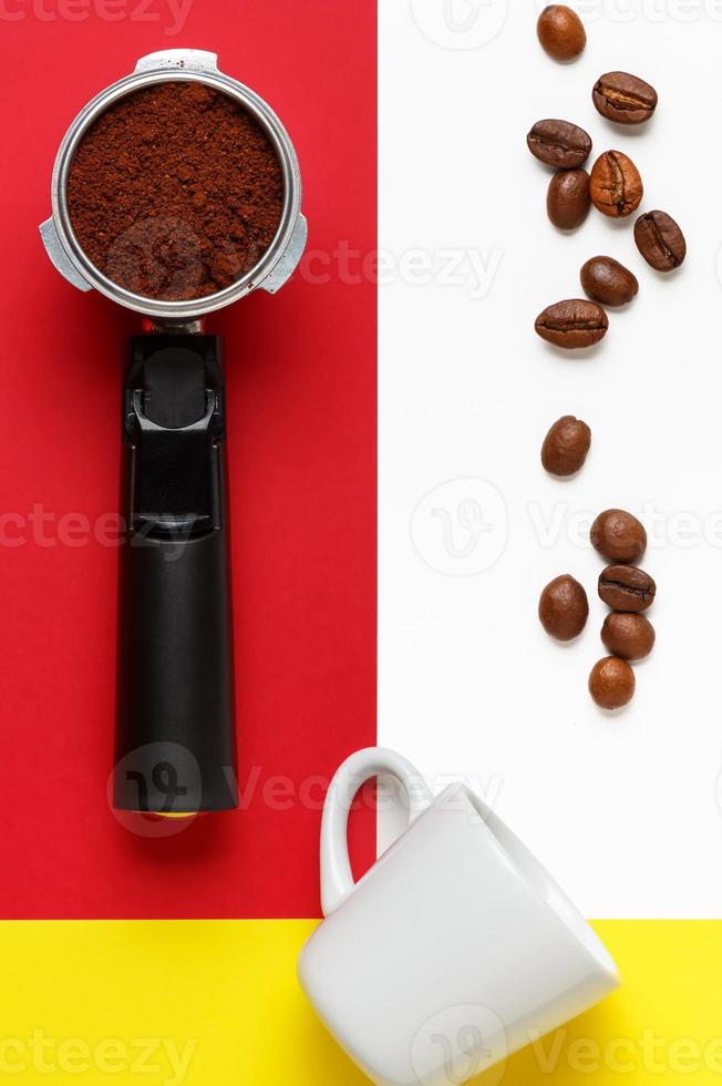 Espresso machine filter holder with ground coffee, coffee beans and
