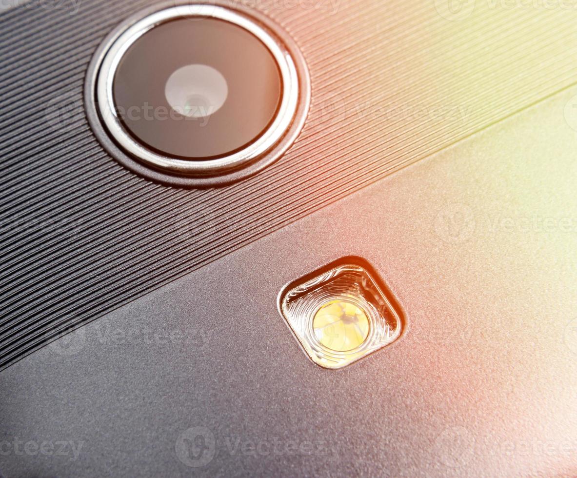 Camera and smartphone flash with light reflection on the right. Close up. photo