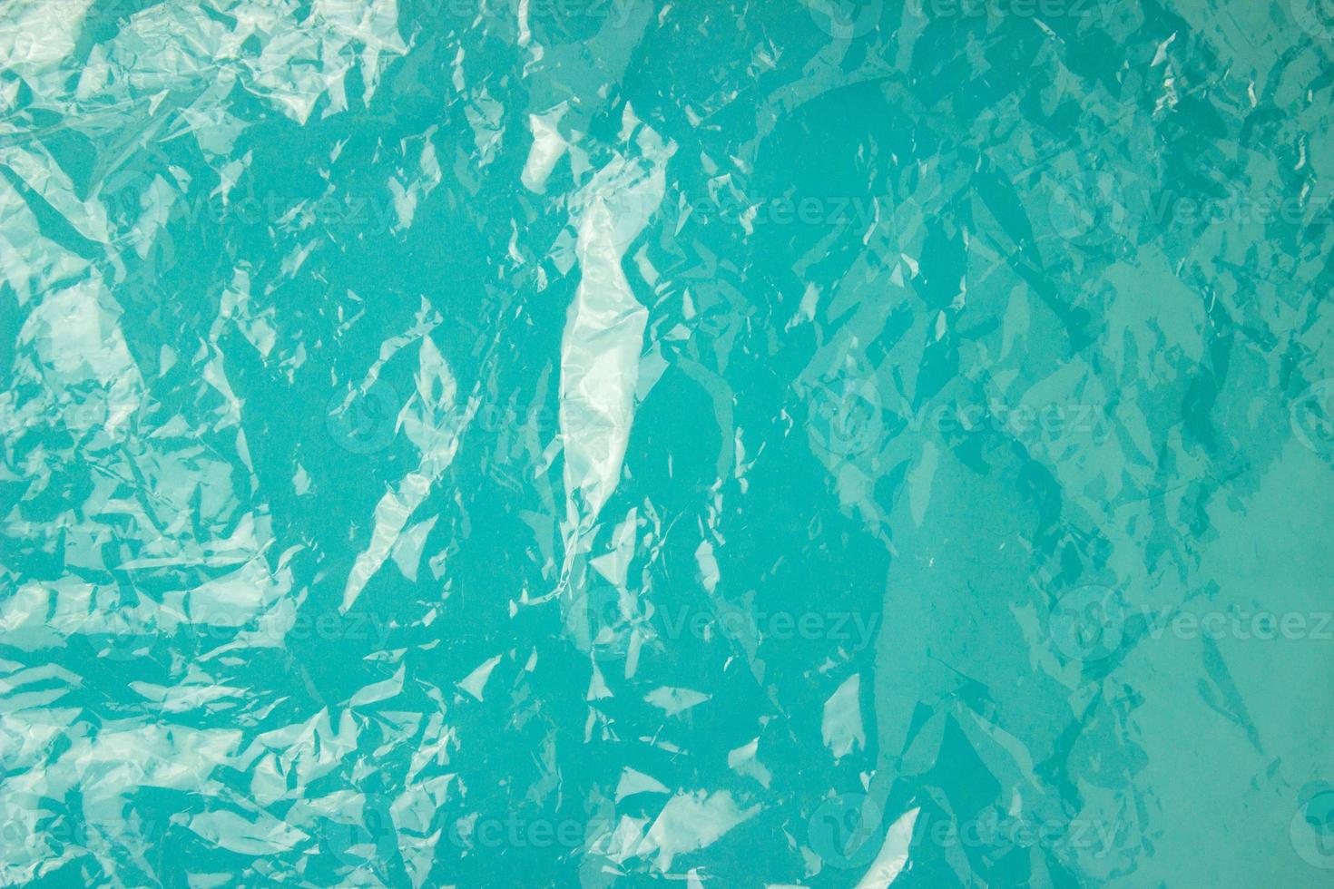 The texture of the plastic bag on a blue background. Crumpled transparent bag, plastic photo