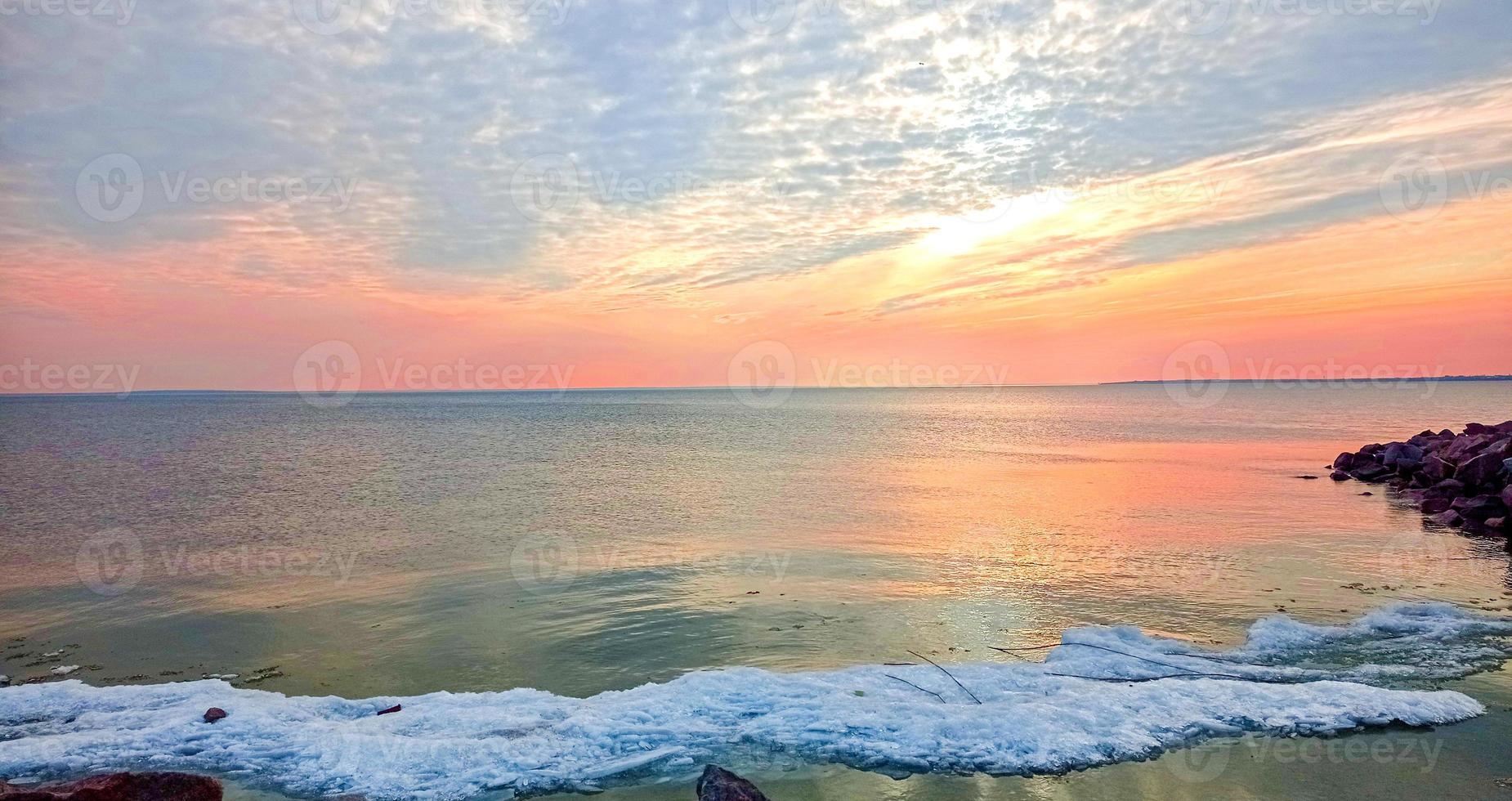 Sunset sky over sea in the evening with colorful clouds photo