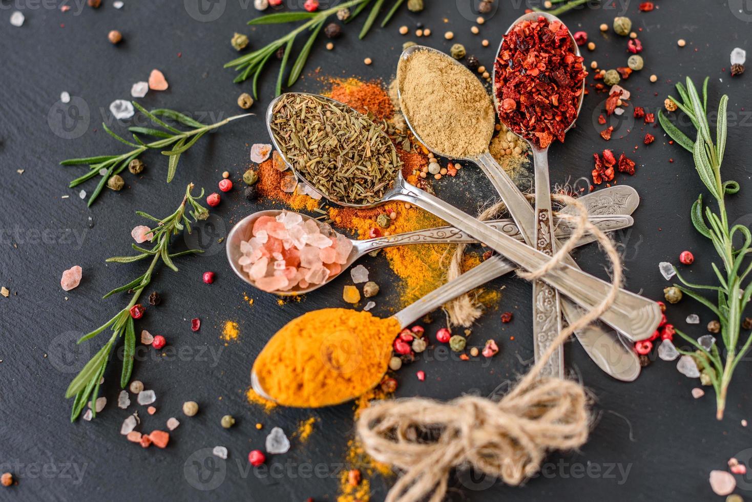 Spices and herbs on old kitchen table. Food and cuisine ingredients photo