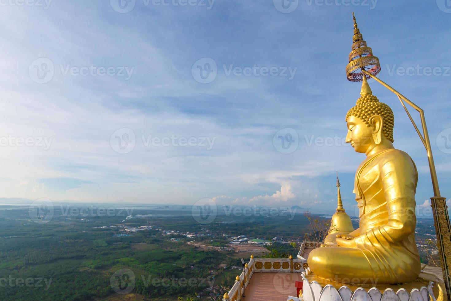 The golden Buddha at the top of mountain, Tiger Cave temple, Krabi Thailand photo