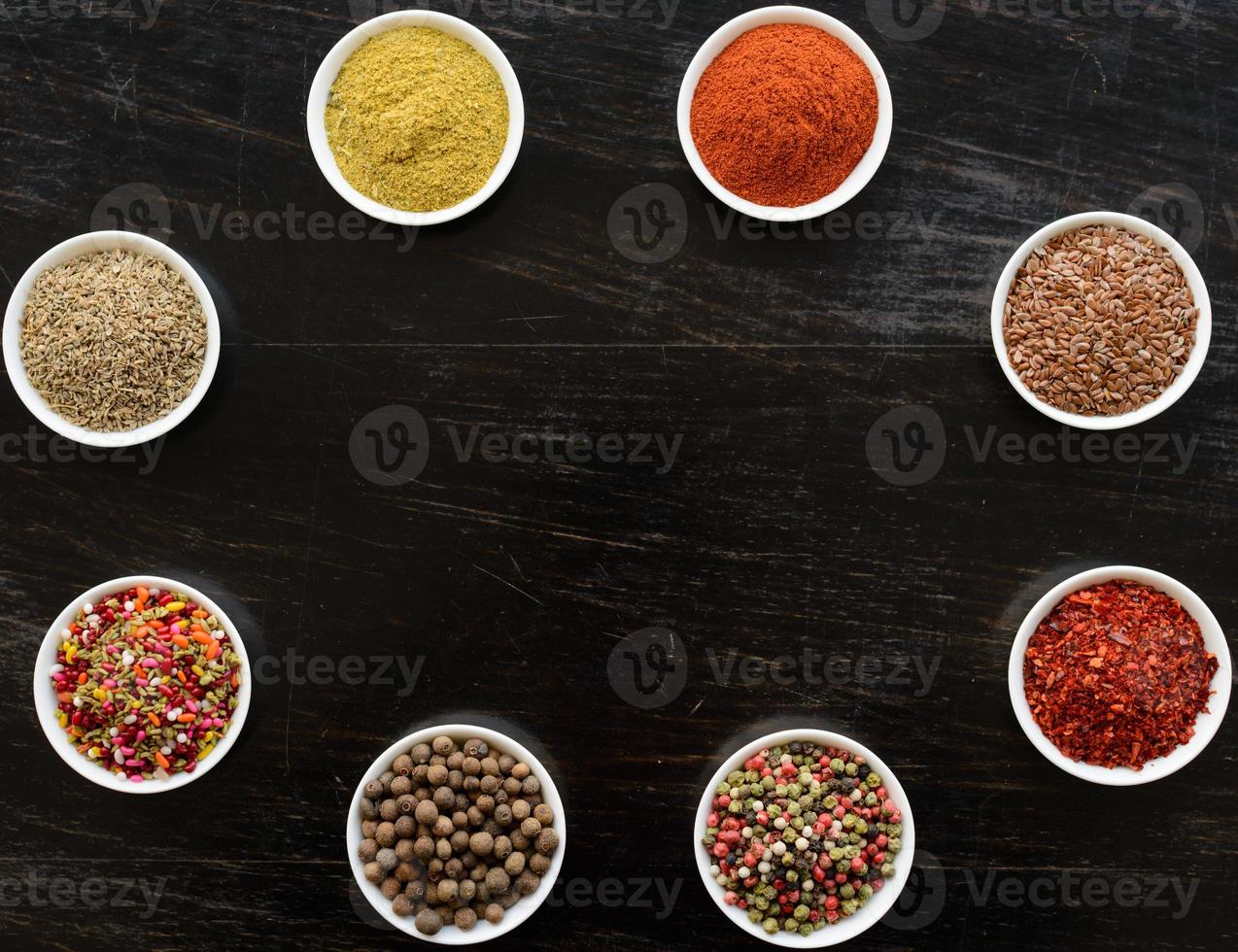 Spices and herbs on old kitchen table. Food and cuisine ingredients photo