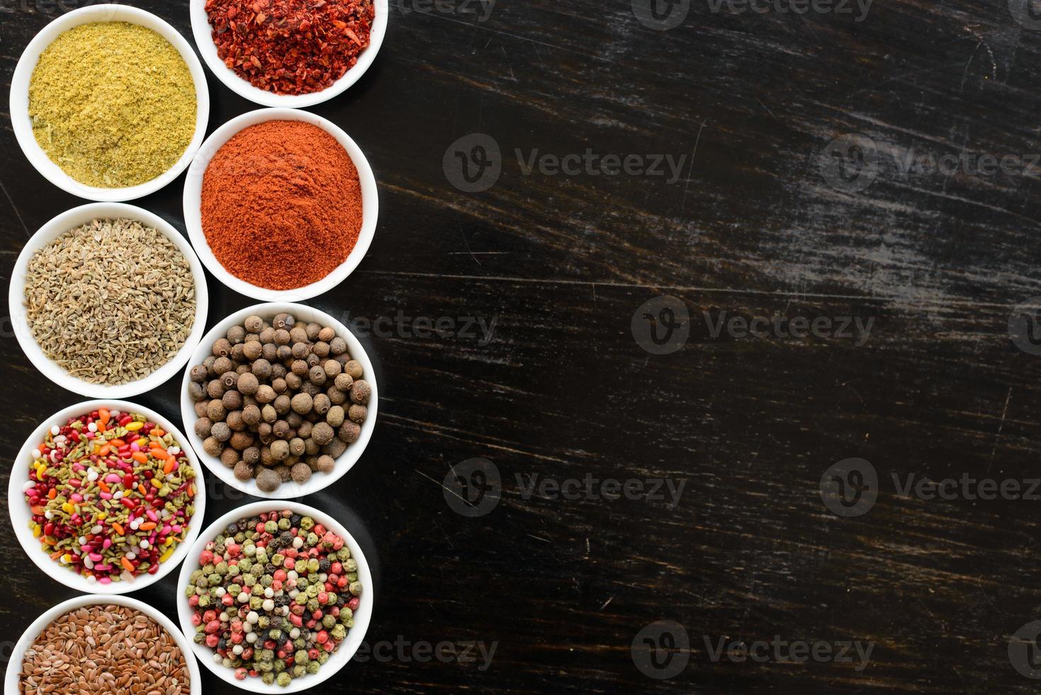 Spices and herbs on old kitchen table. Food and cuisine ingredients photo