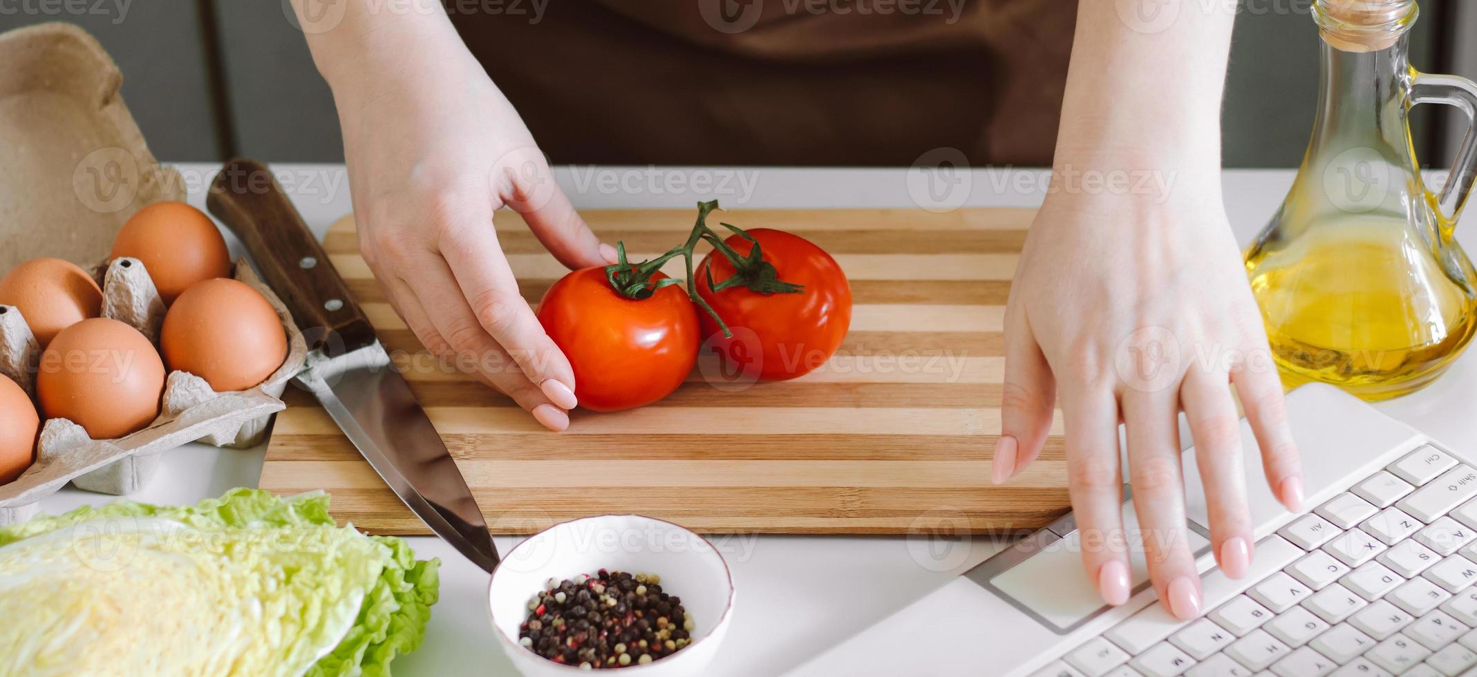 Woman blogger records dietary salad recipe on camera. Online cooking lessons photo