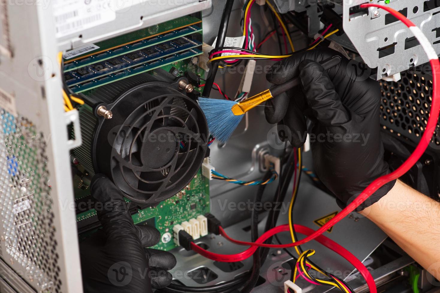 Wizard repairs personal computer with tools and hands. Disassembly of the computer into spare parts photo