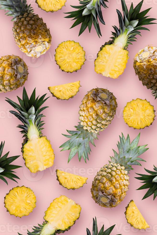 Pineapple fruit and Pineapple slices wallpaper on a pink background. photo